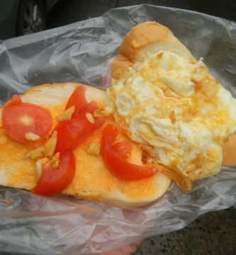 Varias moscas domésticas posadas sobre comida sin tapar
